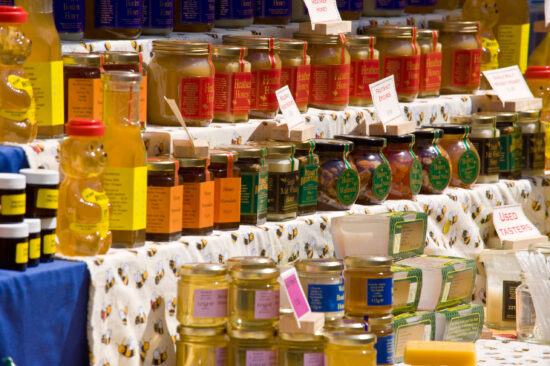 Jars of honey for sale on stall at Hay Food Festival in Hay-on-Wye Powys, Wales.