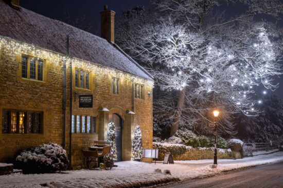 Broadway museum and Christmas tree light decorations at night in the snow